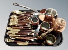 A group of copper kitchenalia, measures, chocolate pot, cast iron pan,