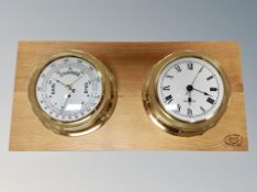 A brass cased ships style barometer and clock mounted on oak board,