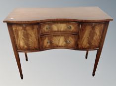 A Regency style mahogany serpentine front side cabinet,