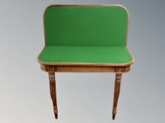 A reproduction mahogany turnover top card table with green baise lined interior,