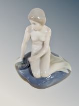 A Royal Copenhagen figure of a Mermaid seated on a rock,