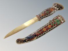A decorative Eastern brass dagger with enamelled grip and sheath