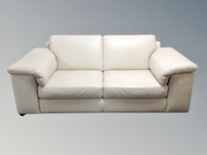 A pair of cream stitched leather three seater settees