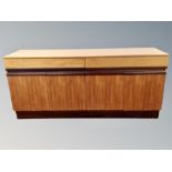 A teak sideboard, fitted cupboards and drawers,