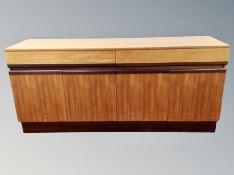 A teak sideboard, fitted cupboards and drawers,