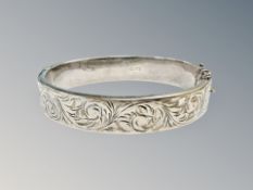 An engraved silver bangle