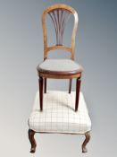 A walnut dining chair and an upholstered footstool on cabriole legs