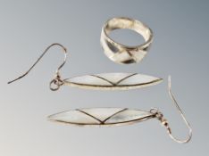 A silver ring and pair of earrings