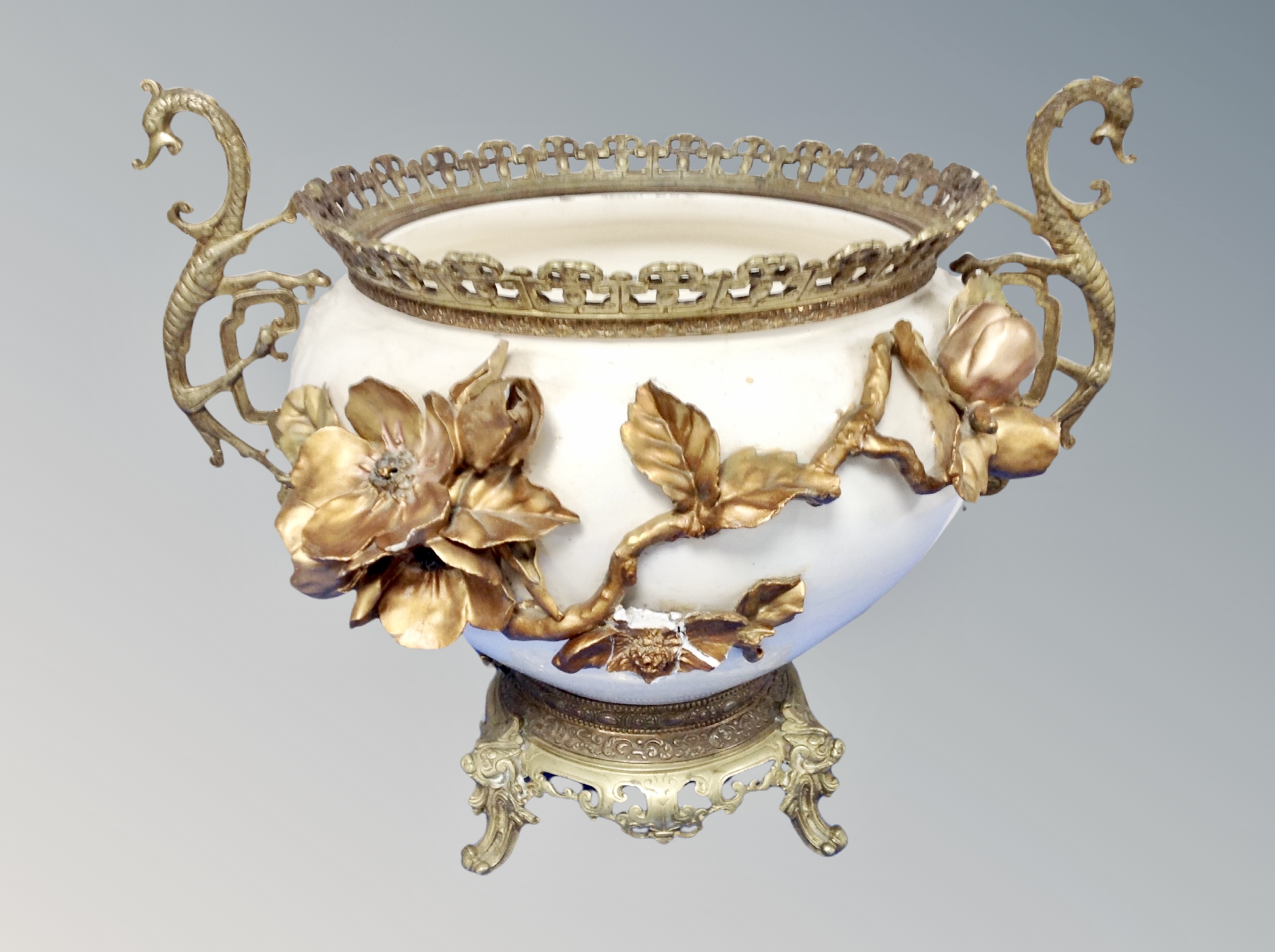 A Victorian ceramic and gilded jardiniere on ornate brass stand,