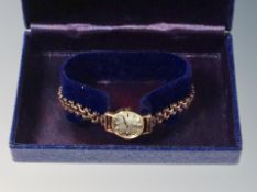 A lady's 9ct Tissot watch on rolled gold bracelet