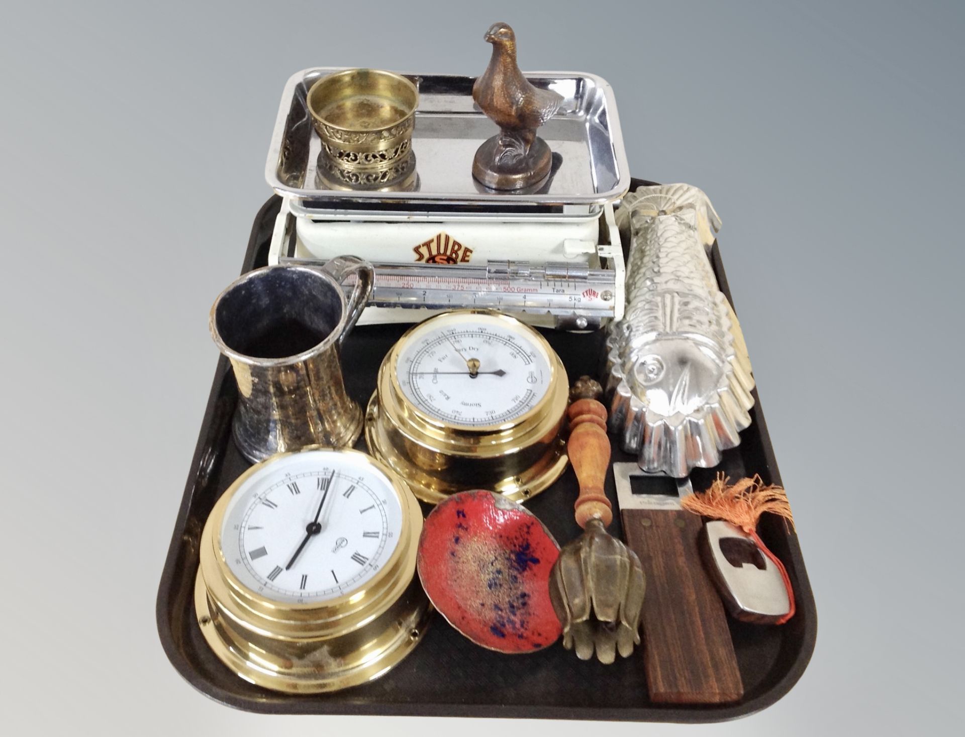 A brass cased barometer and similar quartz clock together with a group of metal wares including