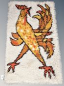 An Eastern woolen rug depicting a cockerel 110 cm x 69 cm