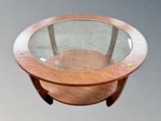 A 1970's circular Astro style two tier coffee table with glass top,