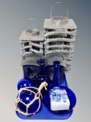 A group of hurricane lamps, several pieces of blue glass ware,