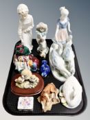 A Bavarian porcelain figure of a woman and geese, Nao figure of a boy, Nao clown,