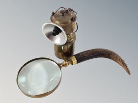 A late 19th century brass bicycle lamp together with a magnifying glass with carved horn handle