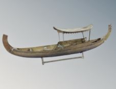 A brass model of a junk boat,