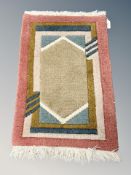 A small Eastern hearth rug 63 cm x 40 cm