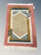 A small Eastern hearth rug 63 cm x 40 cm