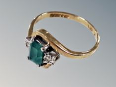 A 9ct emerald and diamond cross-over ring