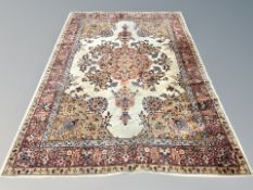 A machine made carpet of Persian design 295 cm x 201 cm