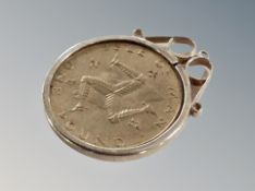 A coin in silver mount