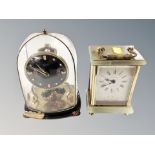 A German mantel clock under glass dome and a further brass and onyx cased quartz mantel clock