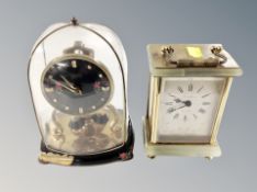 A German mantel clock under glass dome and a further brass and onyx cased quartz mantel clock