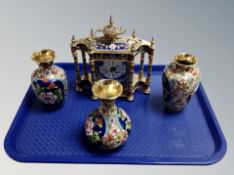 A brass and champleve enamel quartz mantel clock and three similar vases