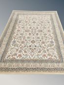A machine made rug of Persian design, on beige ground,