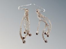 A pair of silver drop earrings