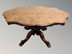A Victorian burr walnut shaped breakfast table on heavily carved base,