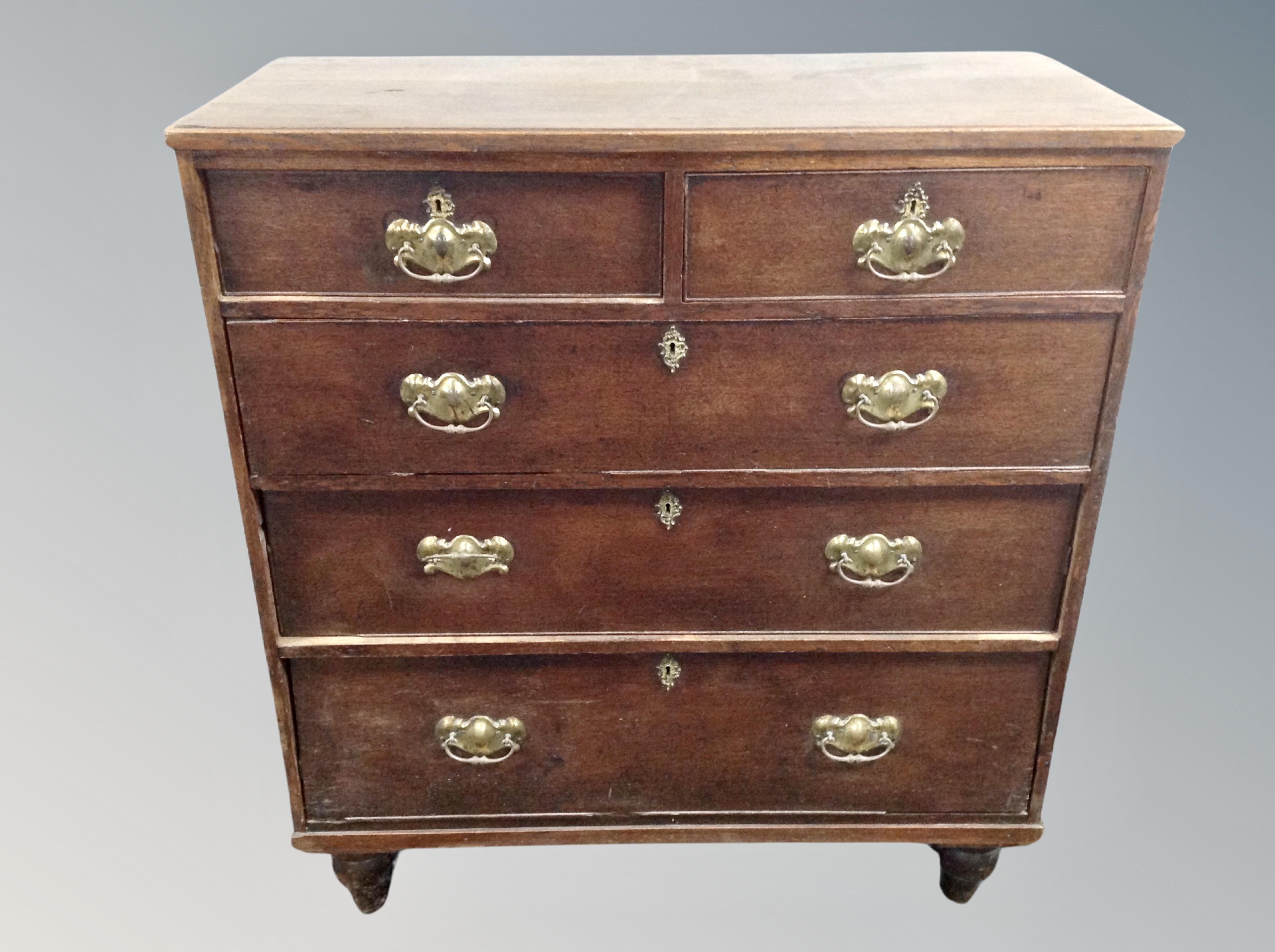 A George III oak chest of five drawers,