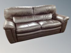 A brown stitched leather three seater settee,