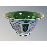 A late 19th century Bohemian green and white glass overlay bowl with hand painted floral decorated