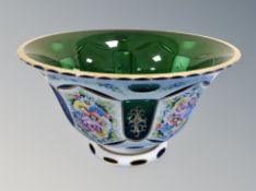 A late 19th century Bohemian green and white glass overlay bowl with hand painted floral decorated