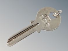 A silver door key