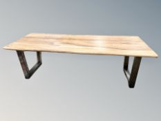 An Indonesian teak table on metal legs, length 240 cm, width 98 cm, height 73 cm.