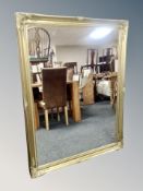 A large Victorian style gilt overmantel mirror,