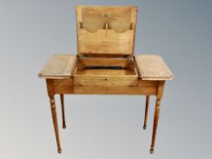 An Edwardian oak storage writing table,