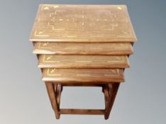 A hardwood and brass inlaid nest of three tables,