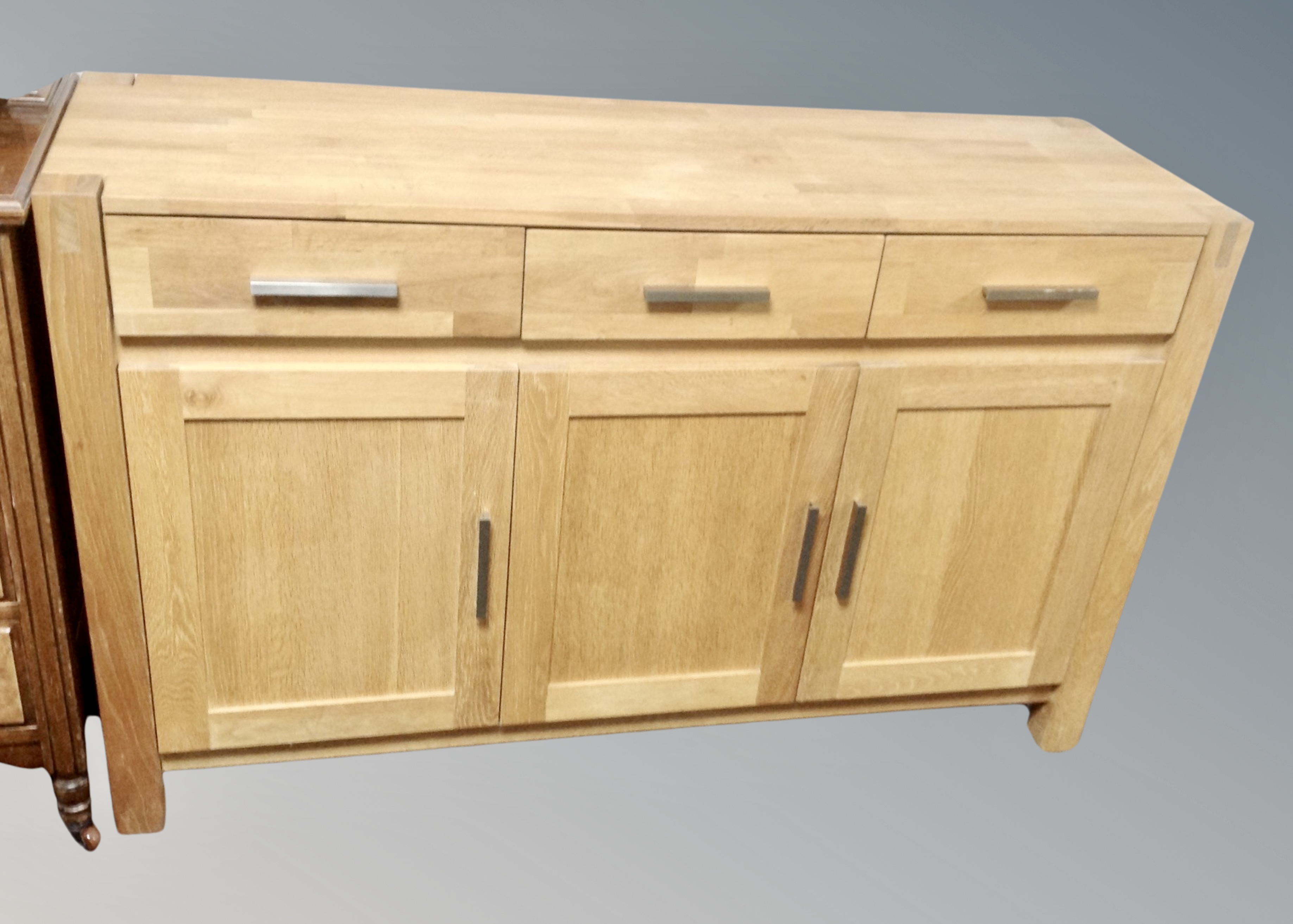 A contemporary oak sideboard fitted with cupboards width 140 cm