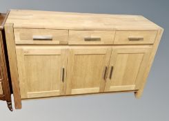 A contemporary oak sideboard fitted with cupboards width 140 cm