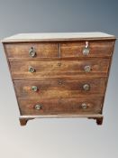 A George III oak chest of five drawers,