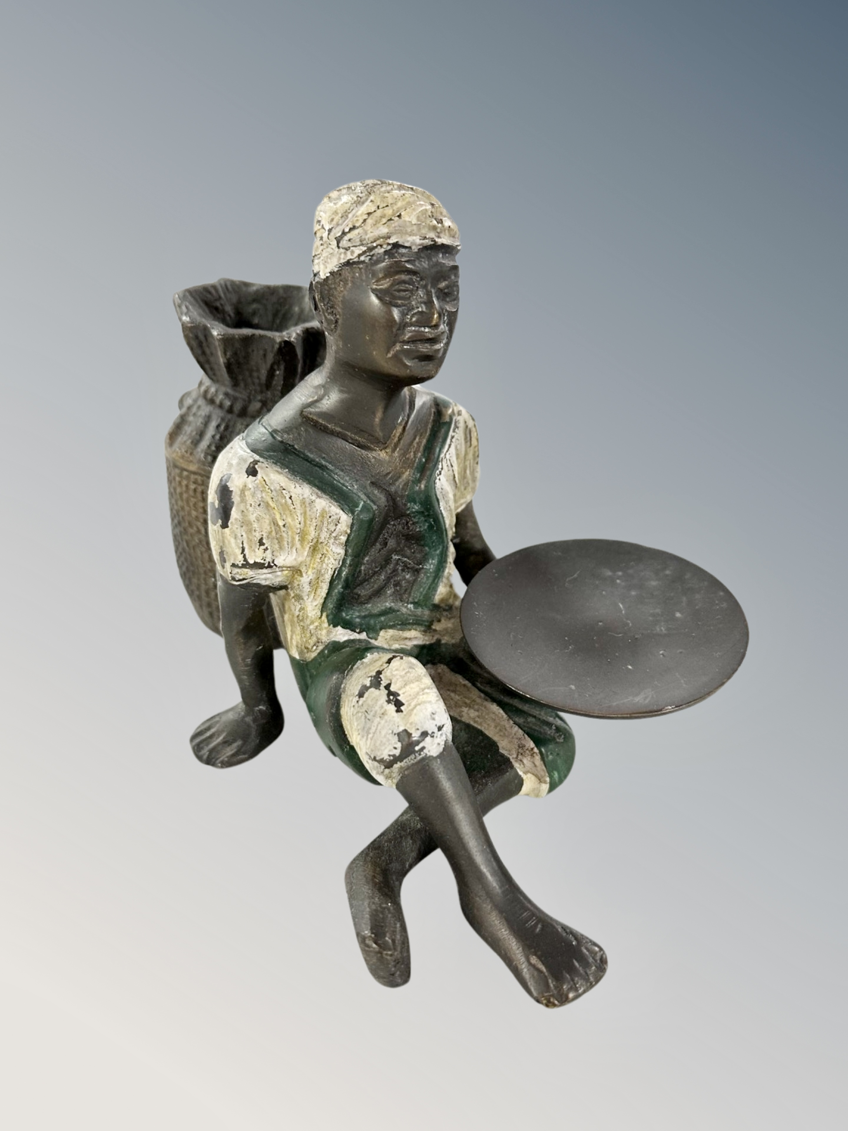 A Bergman style cold painted bronze figure of a seated North African man,