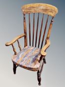 A 19th century elm spindle back armchair