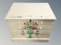 A painted pine low four drawer chest,