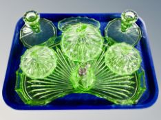 An Art Deco green glass eight piece dressing table set