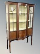 A late Victorian mahogany and satin wood inlaid bowfront display cabinet,