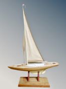 A wooden pond yacht on stand,
